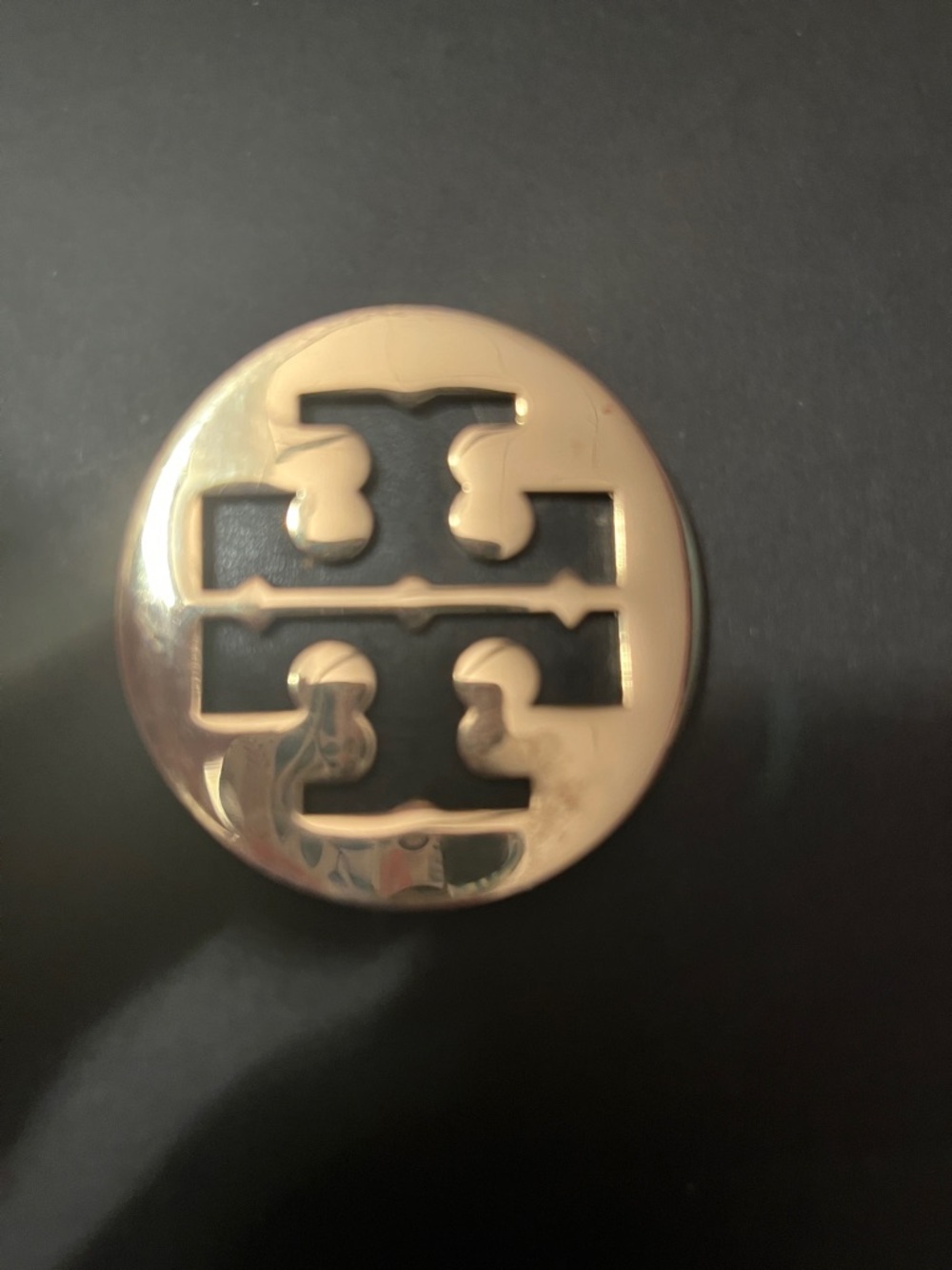 Tory Burch Gold Logo Round Emblem on a black leather back